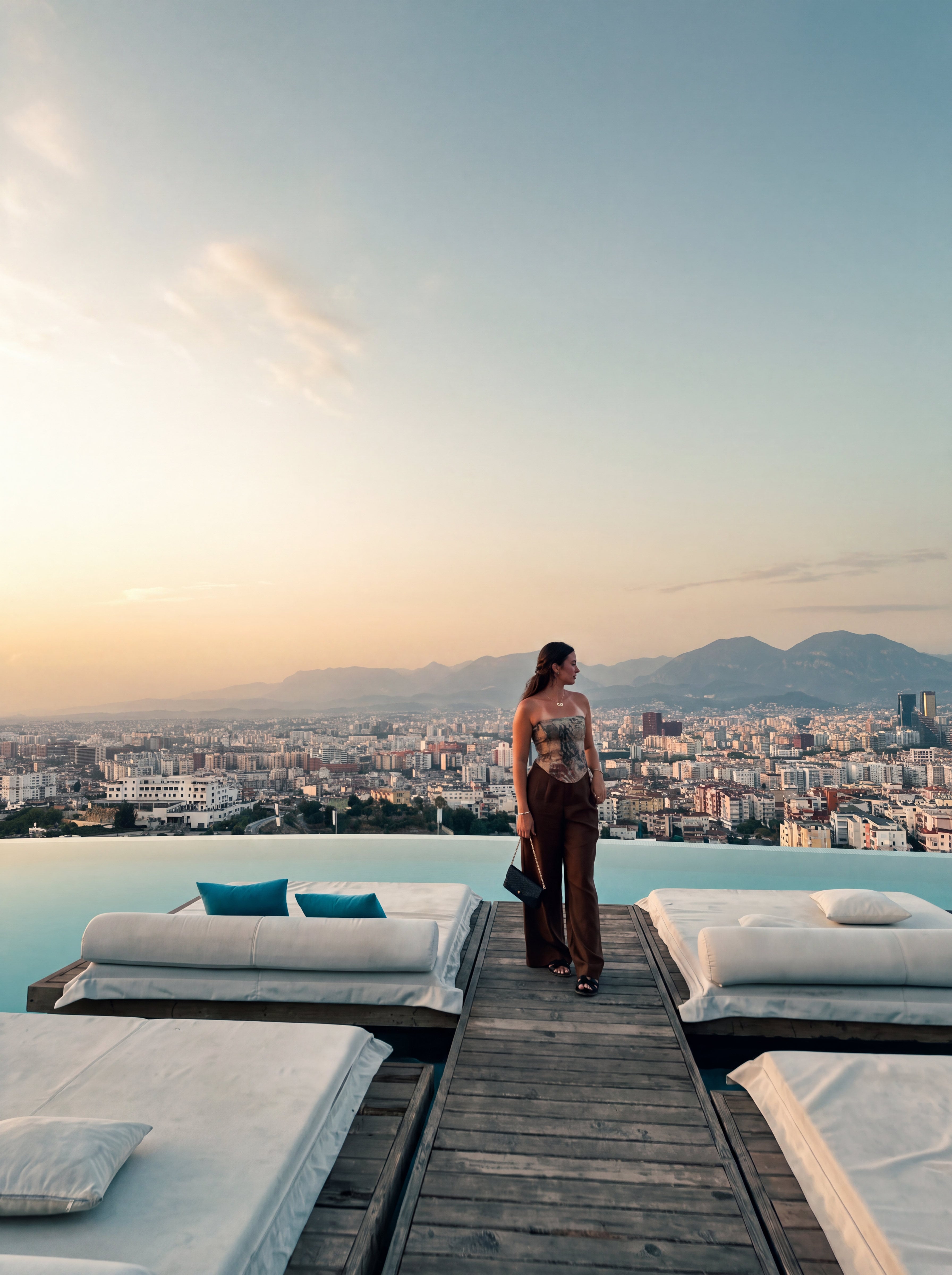 Edita Mackaj on a rooftop pool deck at dusk